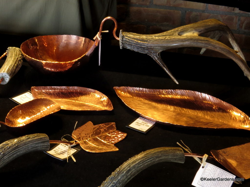 At first glance it looks like a table of leaves, sticks, and antlers. After closer inspection each piece of nature reveals that they are silver and copper metal work, that other then it's metallic shine, is hard to tell from nature's real thing. It is metalwork by Ben & Lael, INC